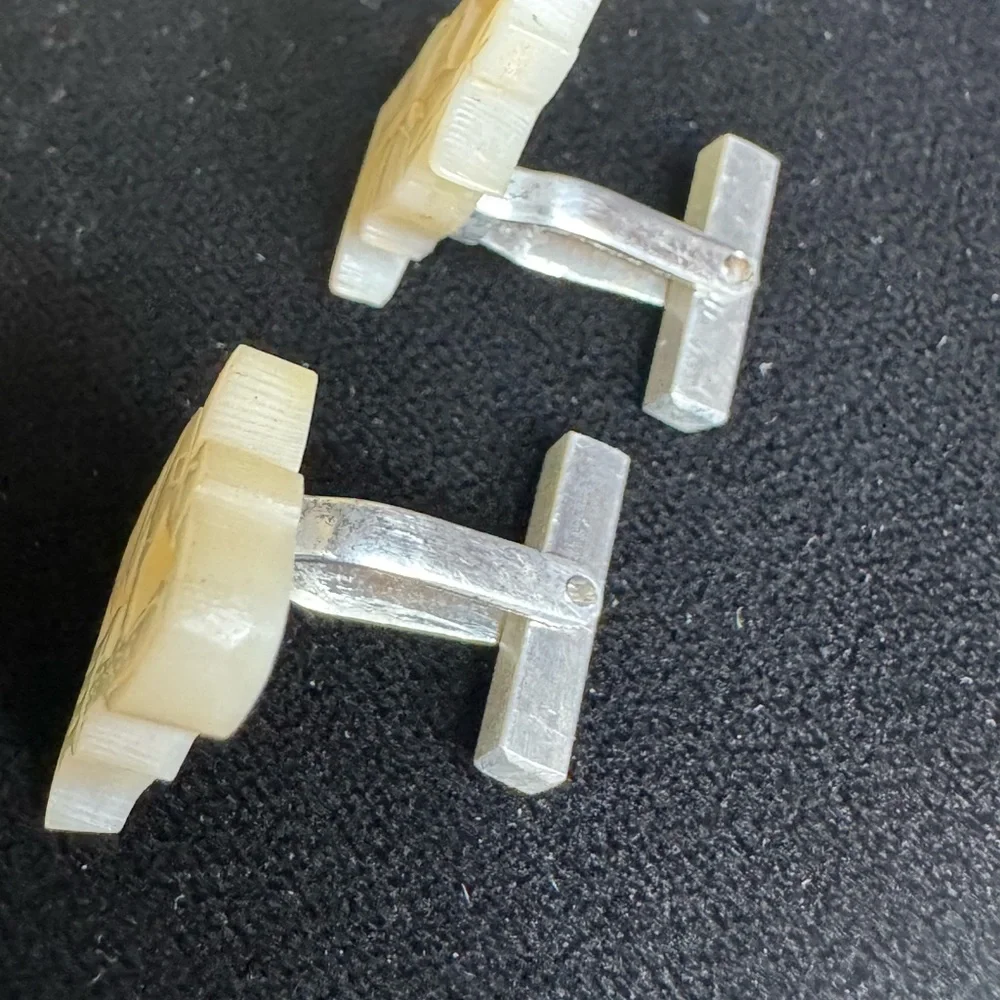 Vintage men’s carved mother of pearl cufflinks of women pouring grain